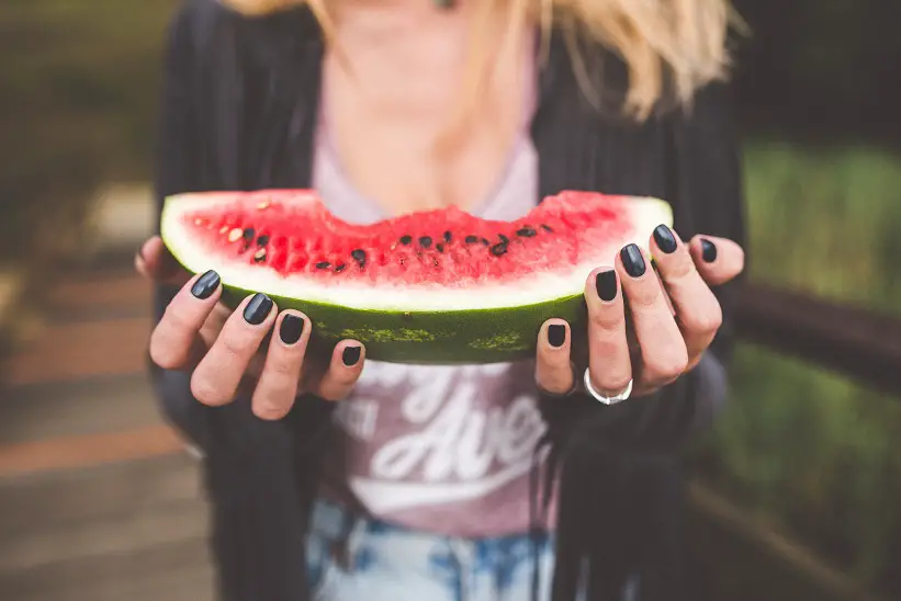 woman making healthy food choices - eating a watermelon